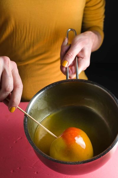 Caramel apple making in a pot