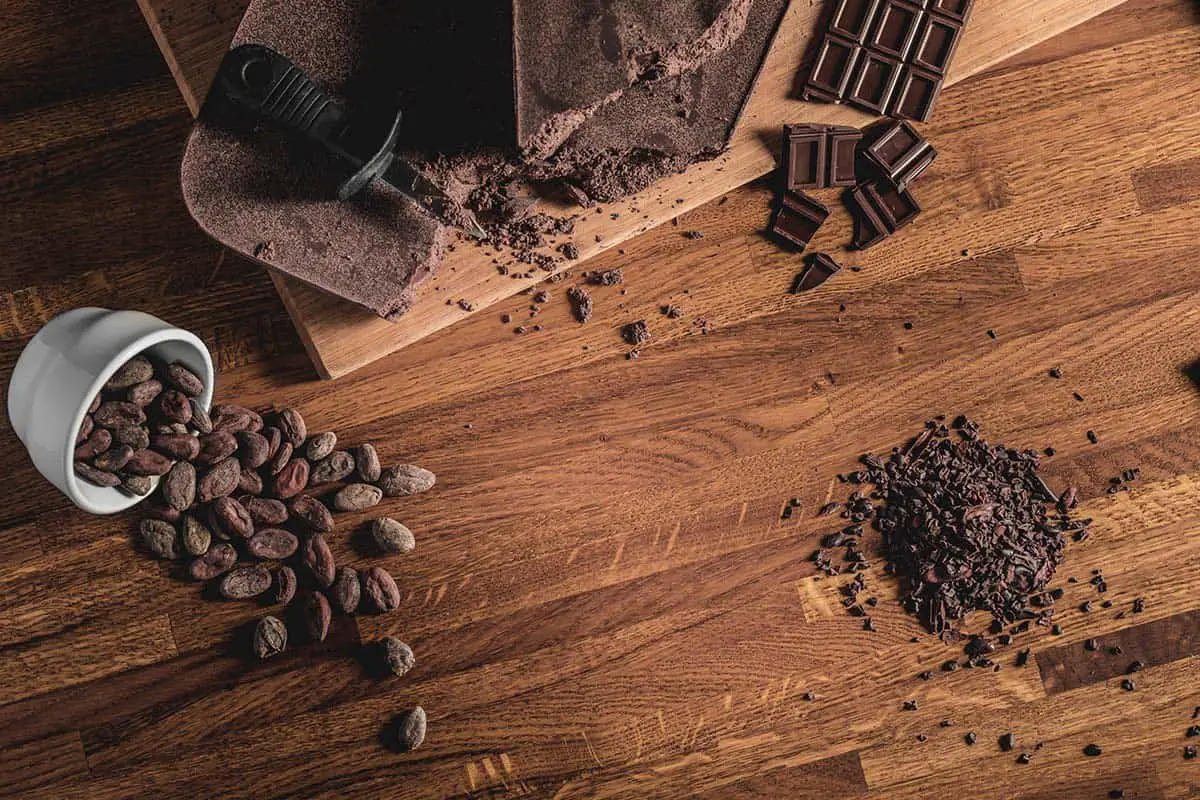 Dark chocolate and cocoa beans on table top