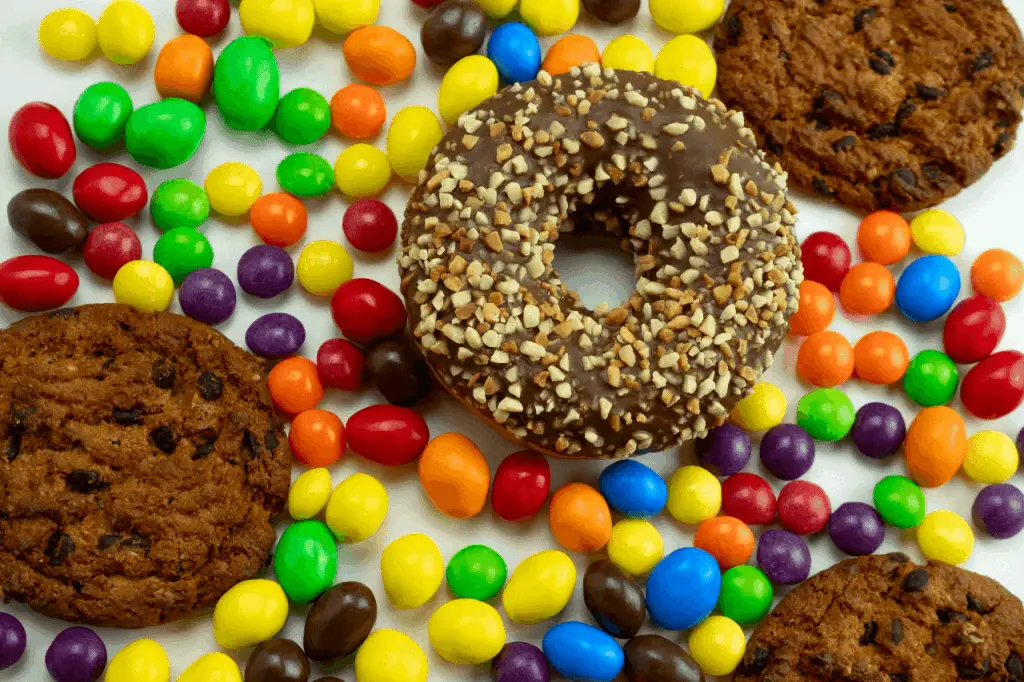 Color candies with cookies and a donut.