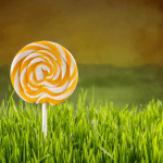 Yellow lollipop standing in the grass